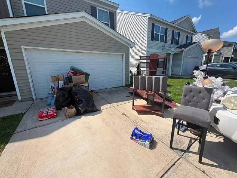 Driveway packed with junk before Junk Rooster
