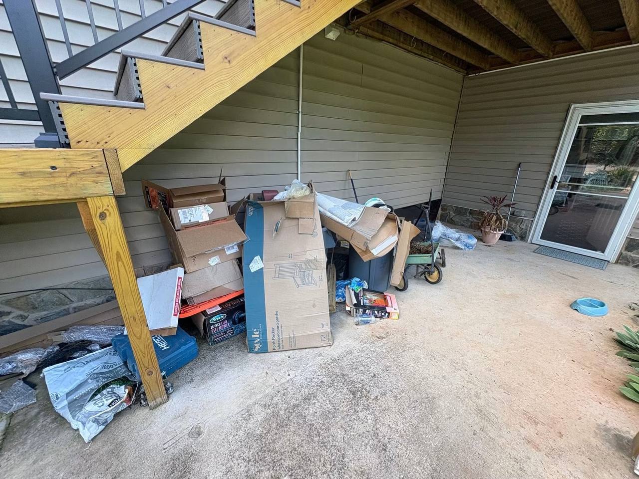 Carport packed with junk before Junk Rooster